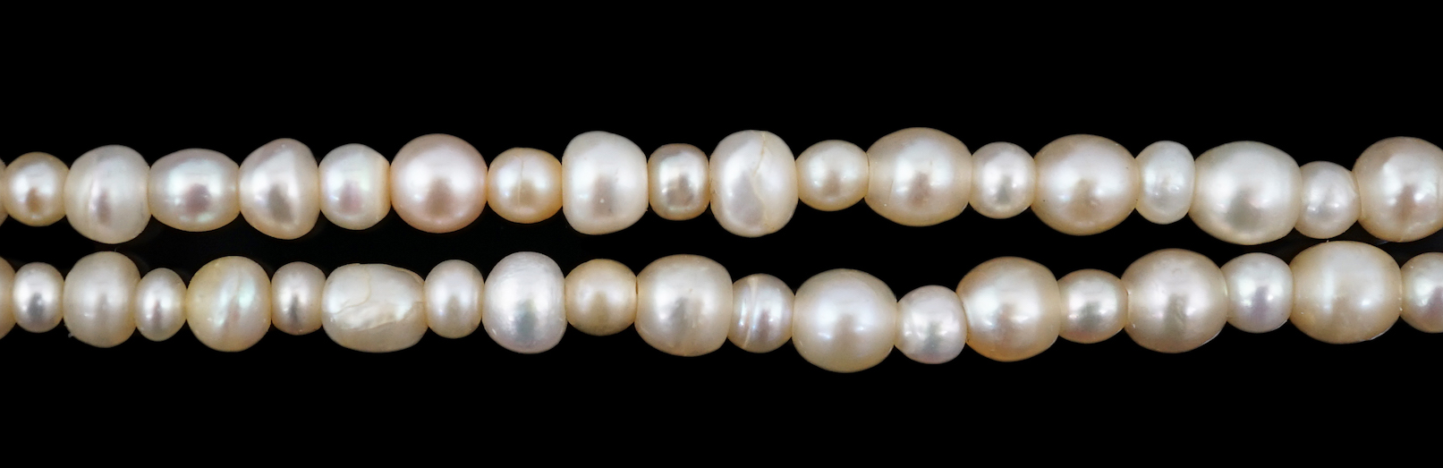 A late 19th century single strand graduated natural saltwater pearl necklace, with a French 18ct white gold and millegrain set diamond marquise shaped clasp